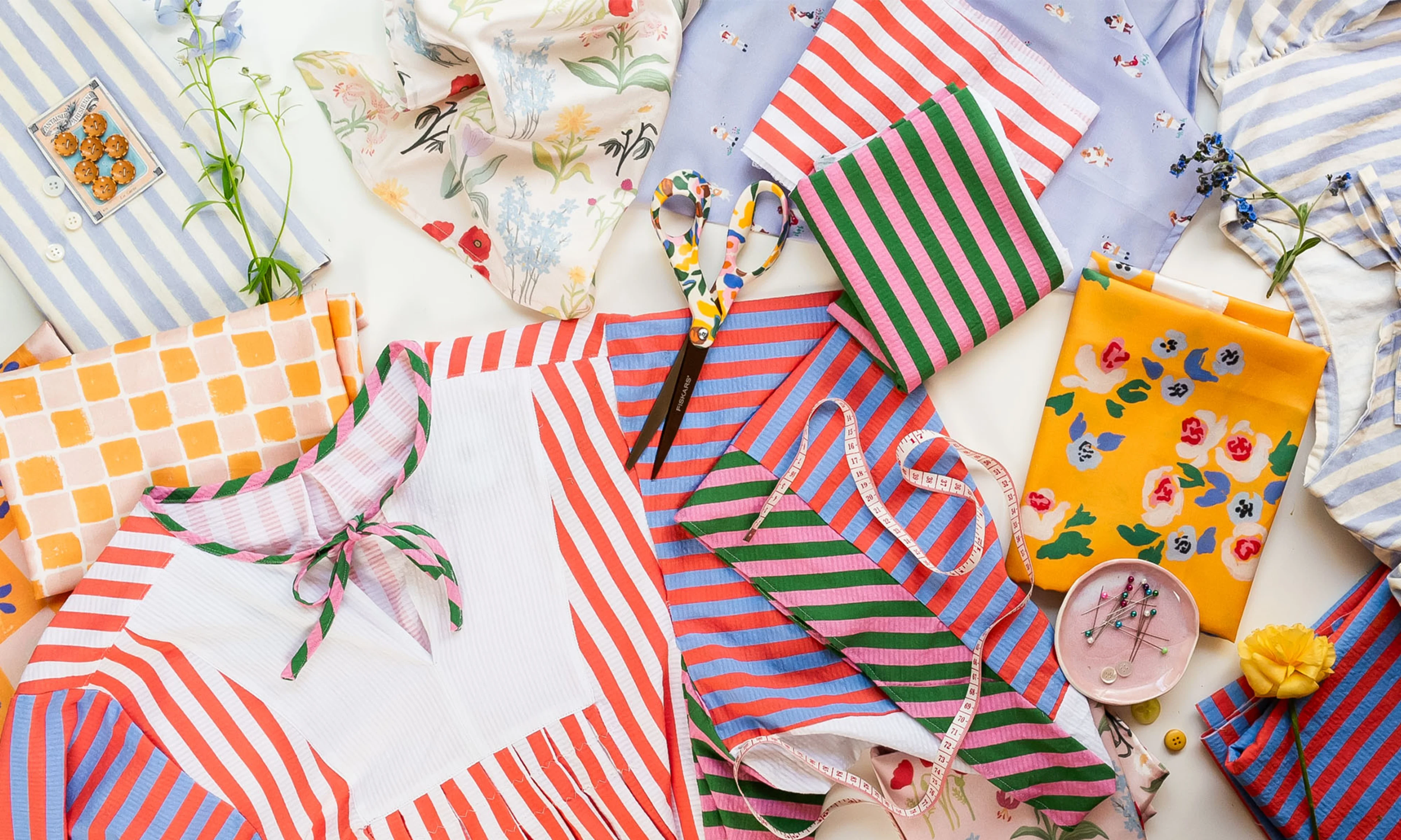 A laydown of fabric swatches and finished projects created by Brittany Jepsen from The House That Lars Built.