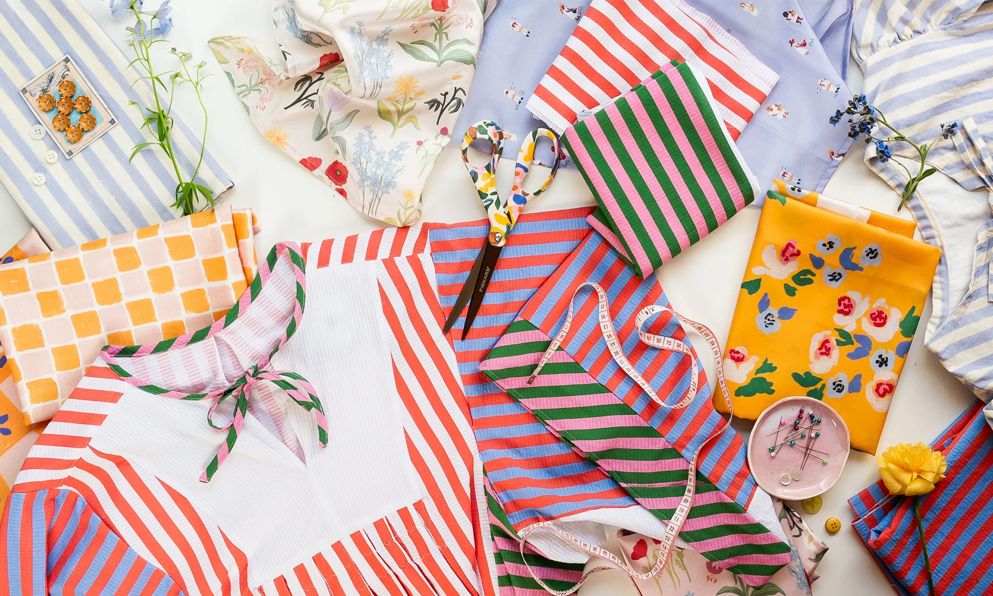 A laydown of fabric swatches and finished projects created by Brittany Jepsen from The House That Lars Built.