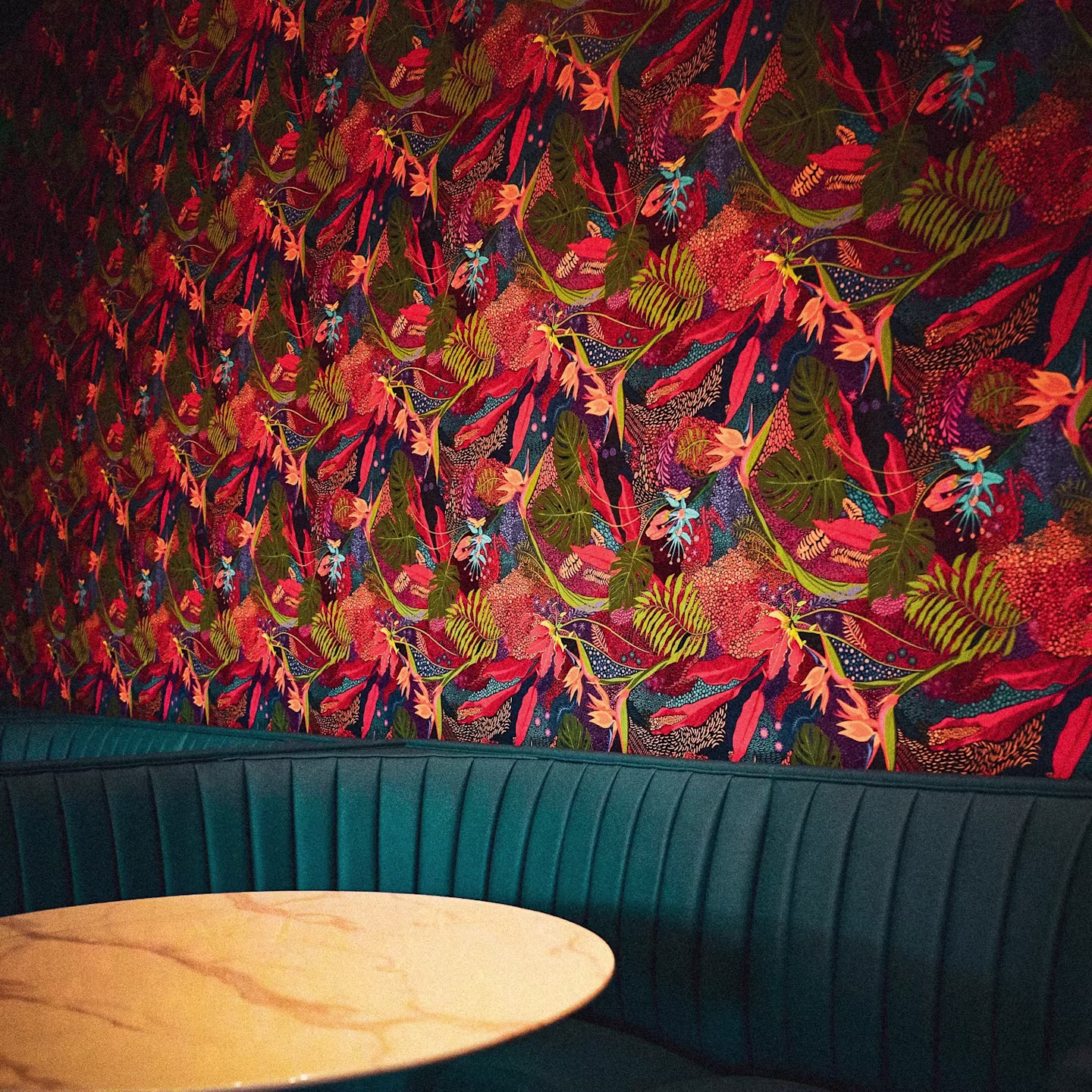 Botanical wallpaper above a booth