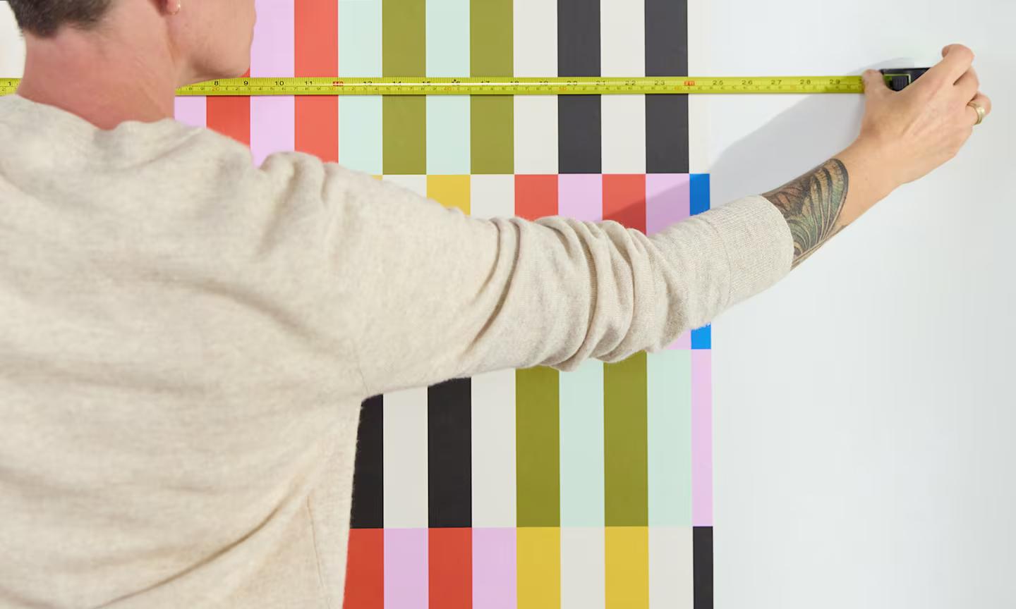 Person measuring walls for wallpaper