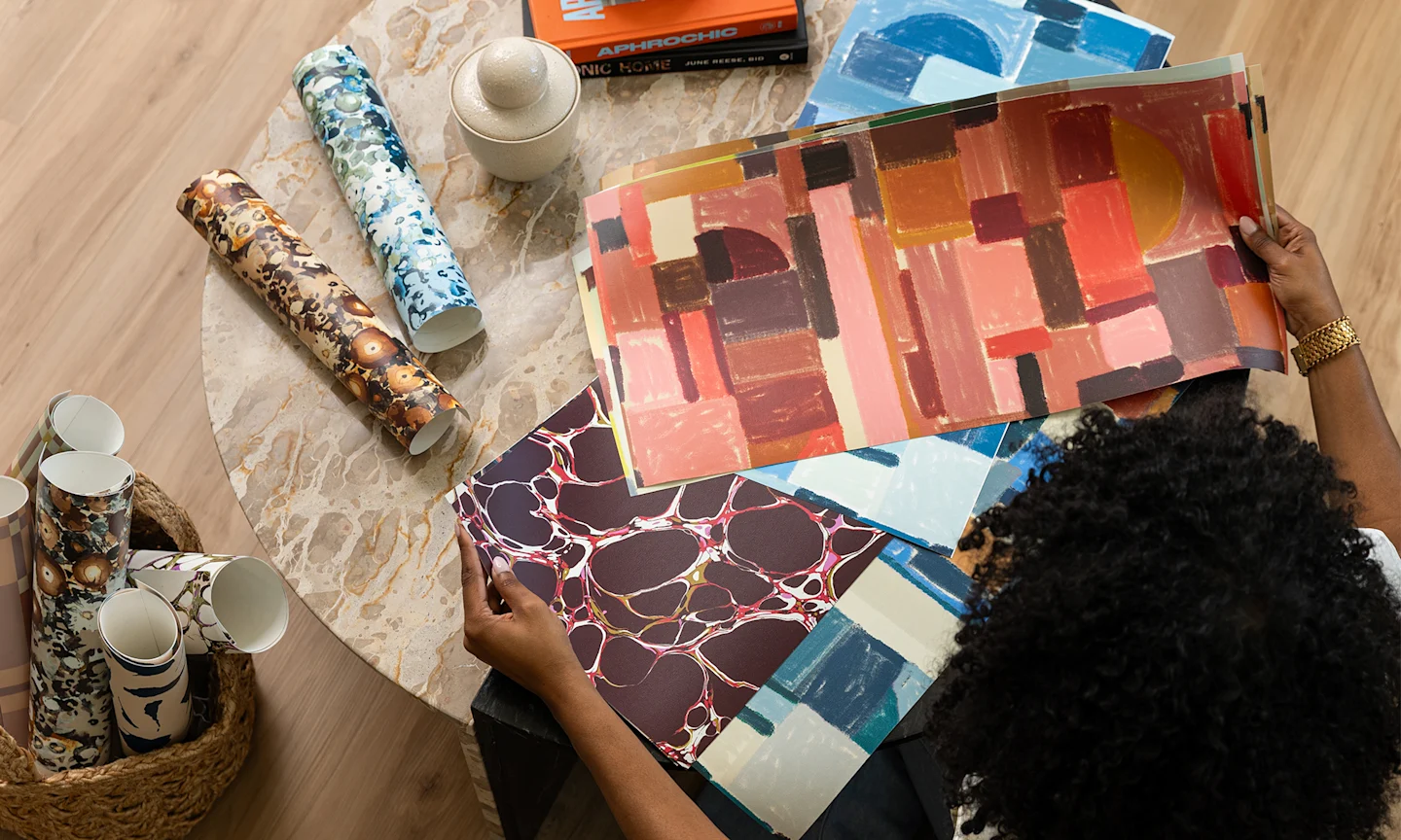 Marie of Indigo Pruitt assessing samples of her designs on Spoonflower wallpaper.