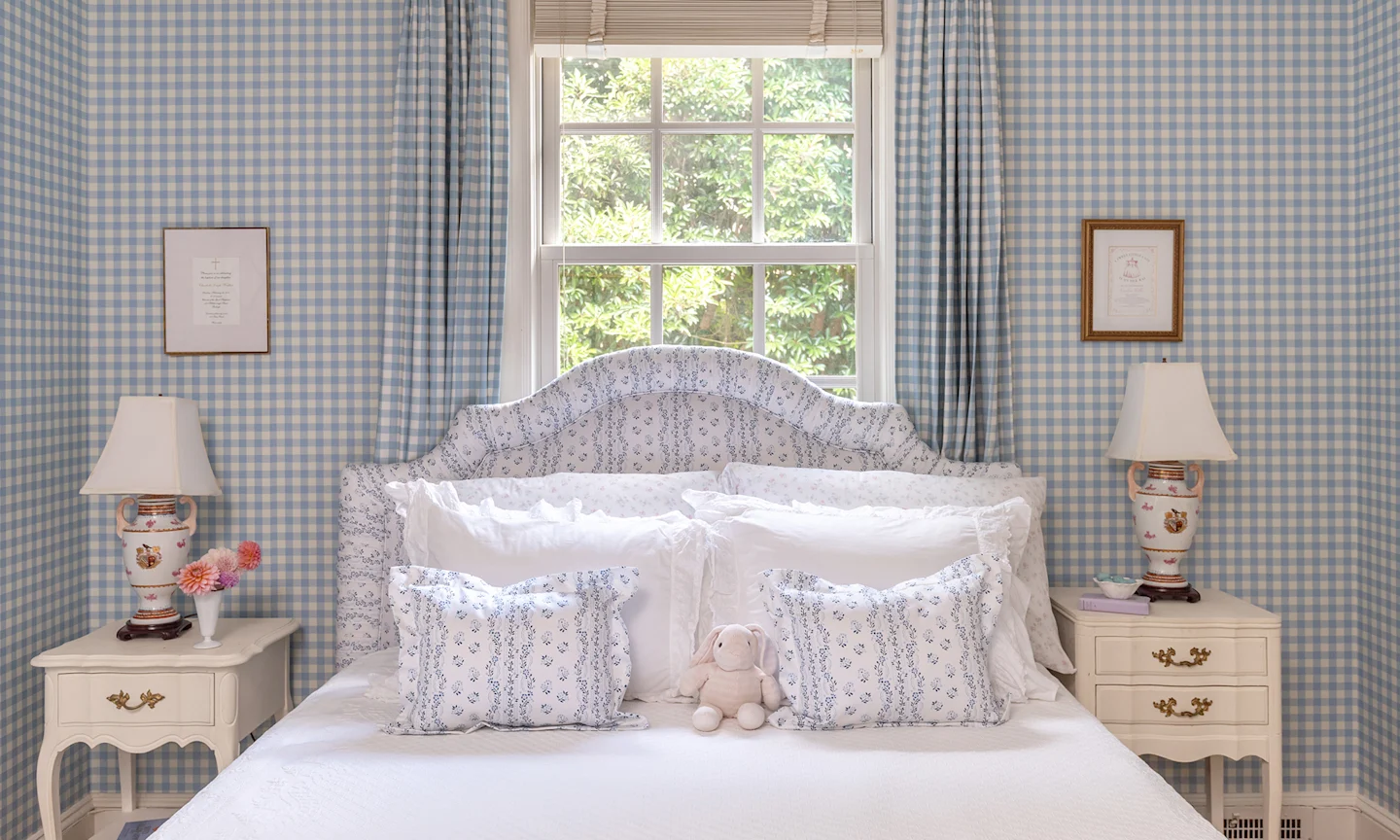 Bedroom with blue gingham wallpaper.