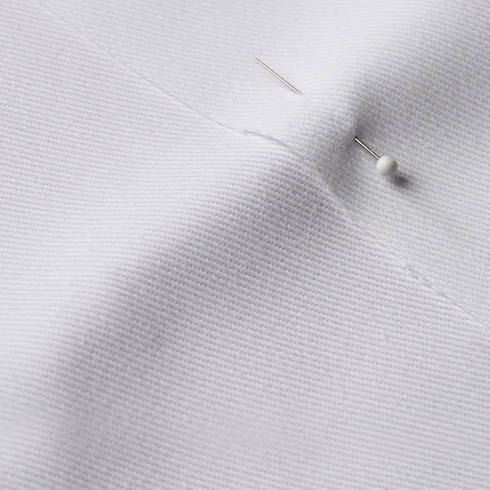 Dogwood Denim fabric with a seam and a pin through 