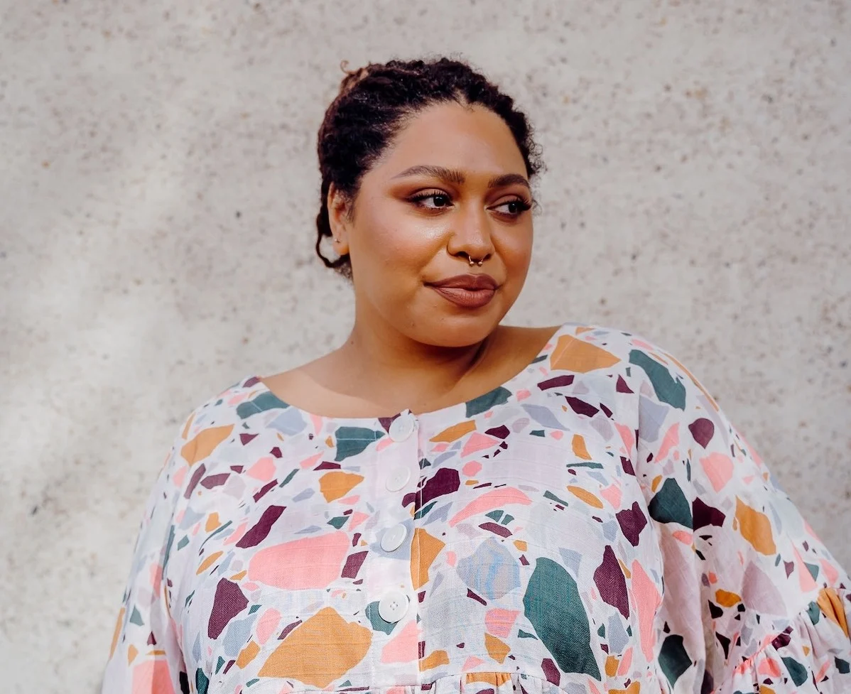 A model wearing an abstract print top made with organic sweet pea gauze