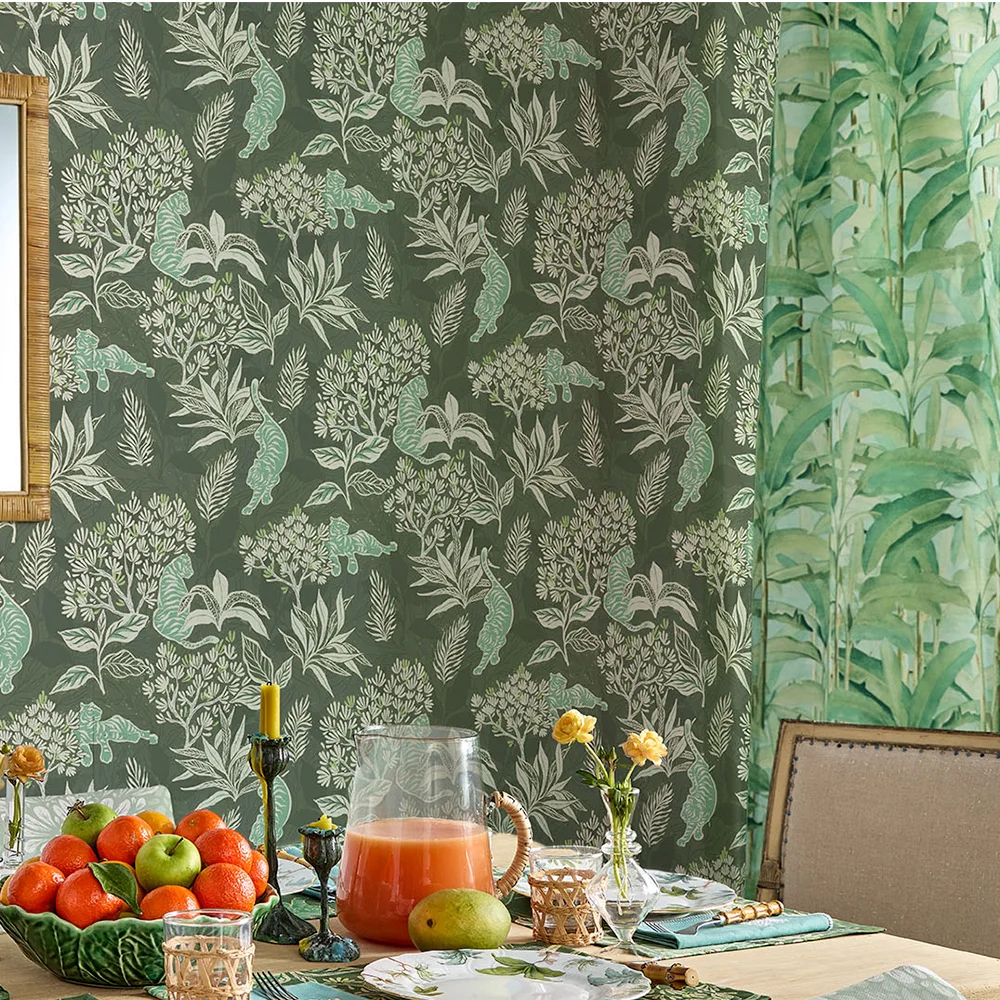Dining room with green tiger jungle wallpaper and lush tropical leaves curtains.