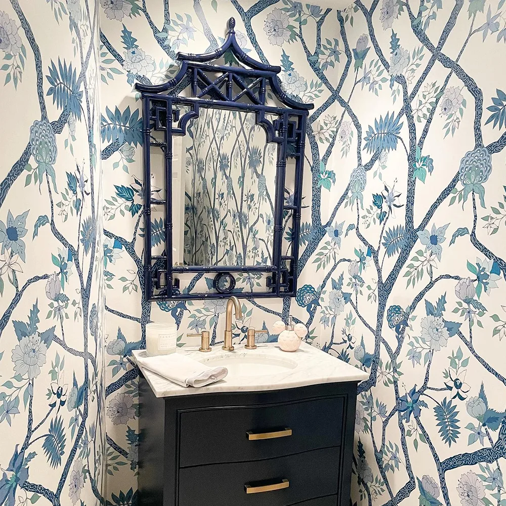 Blue branches wallpaper in a powder room.