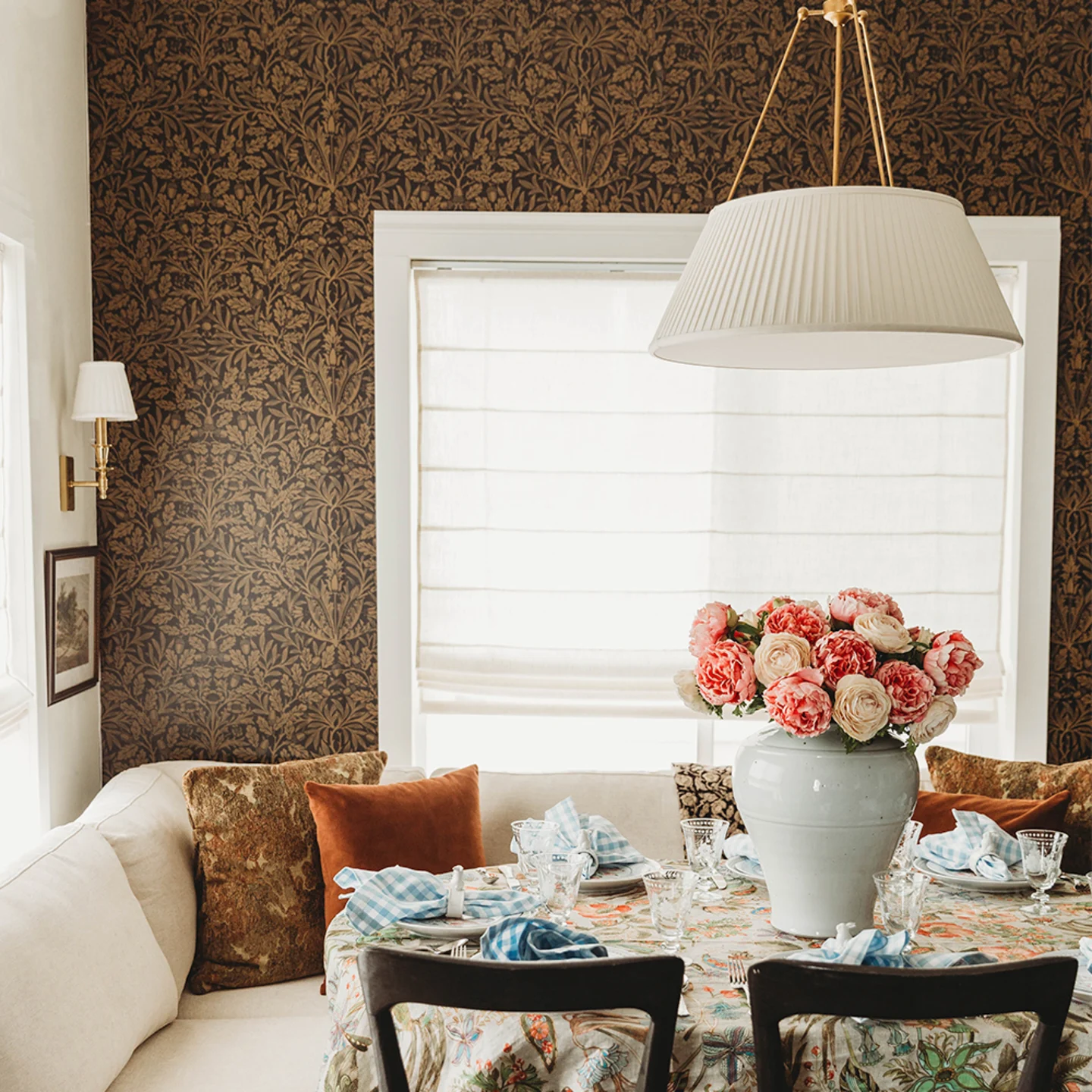 Brown morris inspired wallpaper in a dining nook.