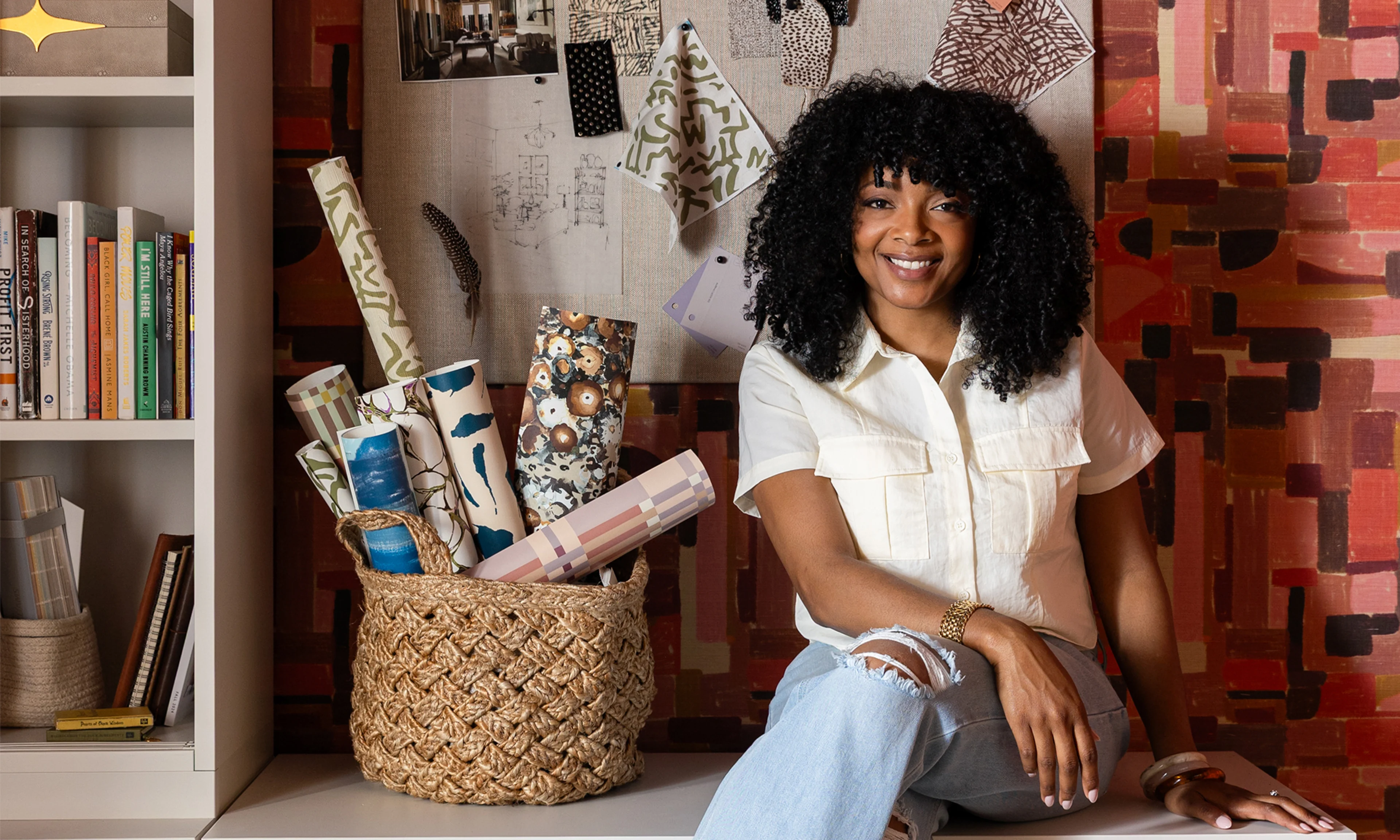 Photo of Marie of Indigo Pruitt in a home office space with her design on the wallpaper.