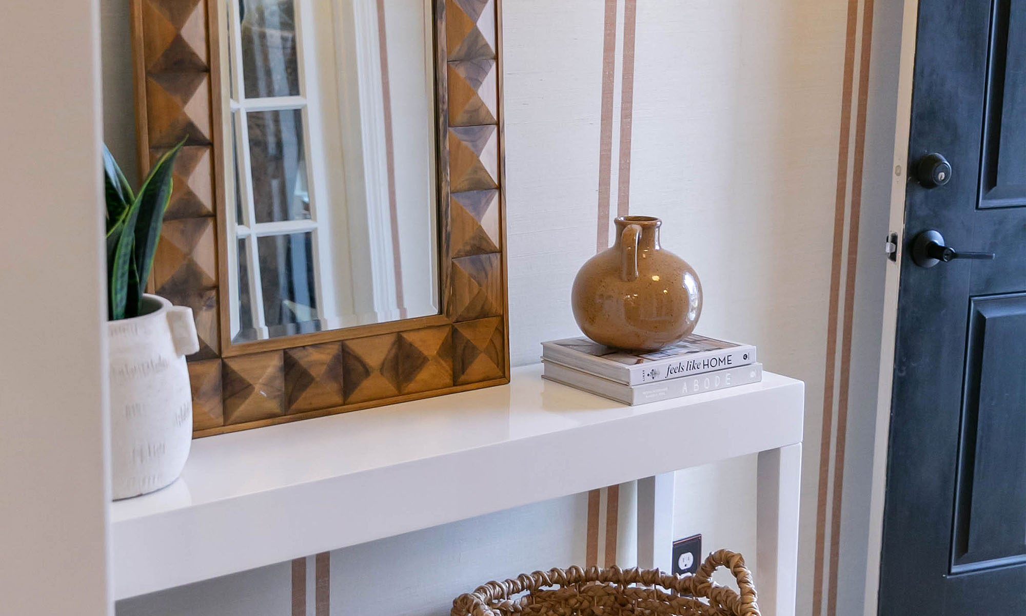 An entryway wallpapered in traditional brown striped wallpaper.