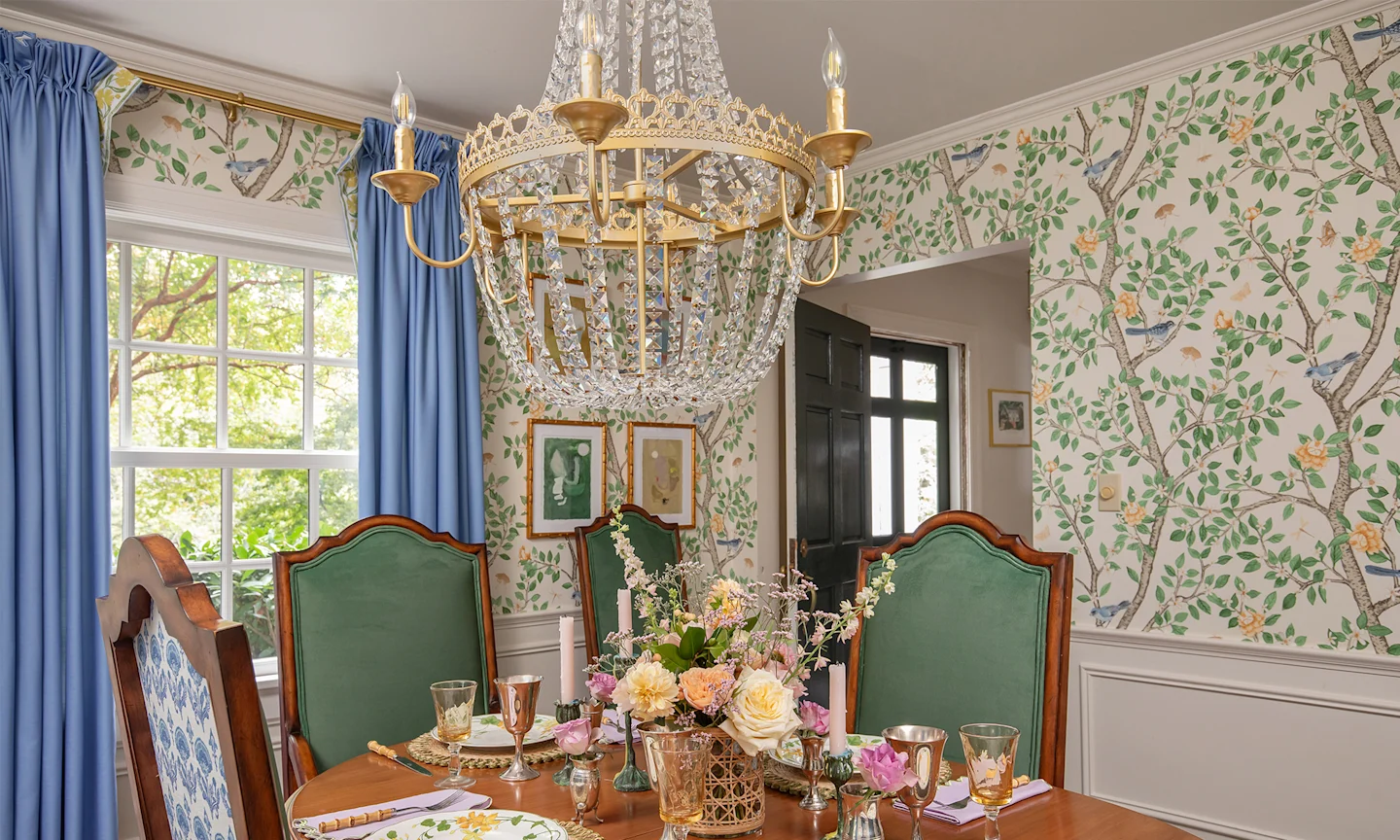 Dining room with floral branch wallpaper.