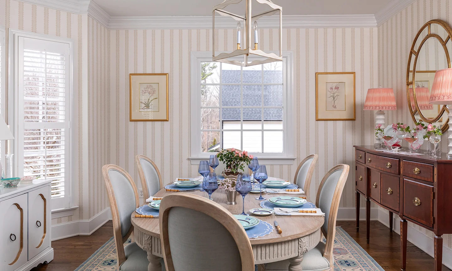 Dining room with neutral striped tan wallpaper.