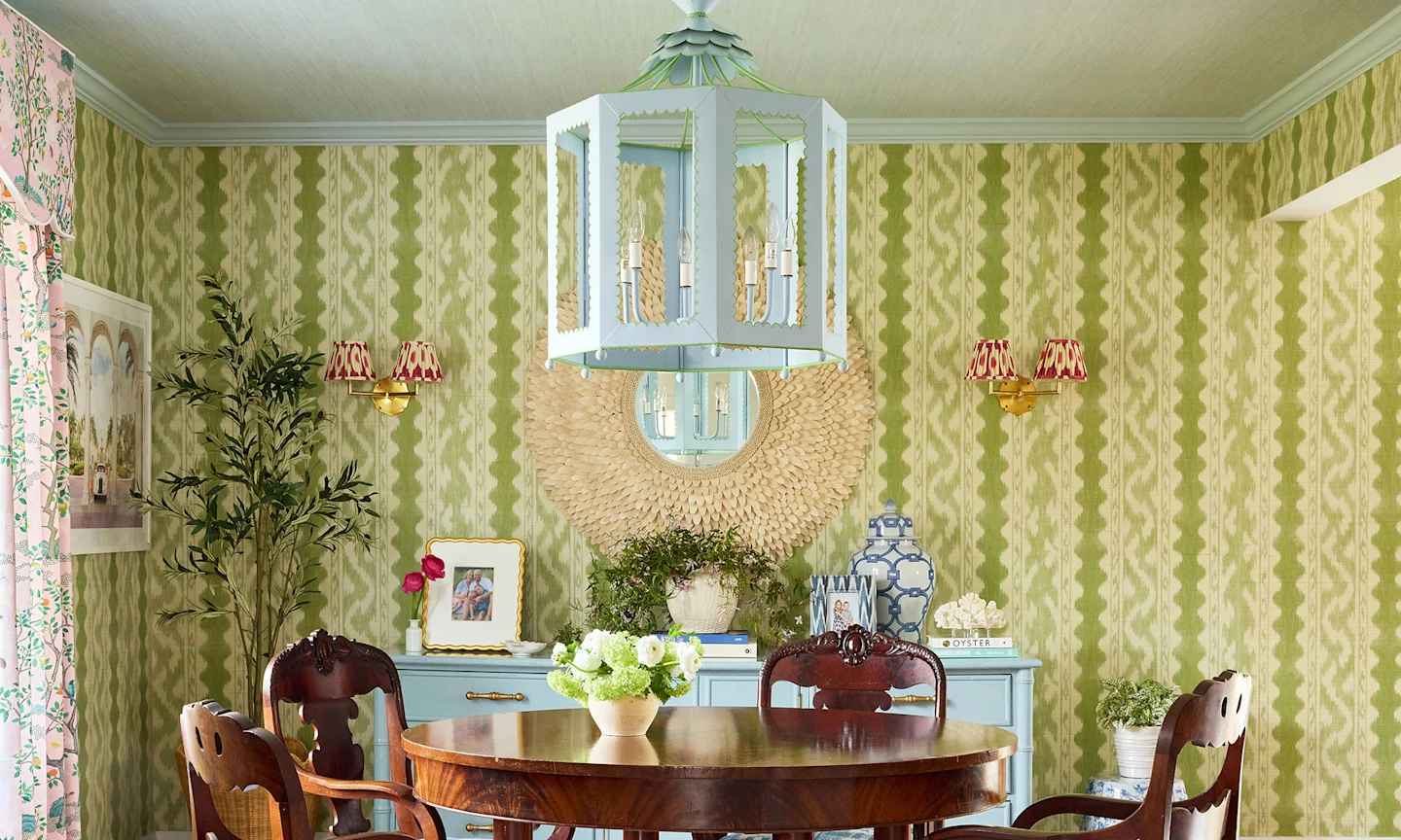 Dining room with green ikat striped wallpaper.