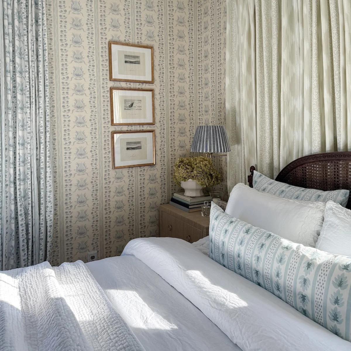 bedroom with wallpaper, duvet, pillows, and curtains
