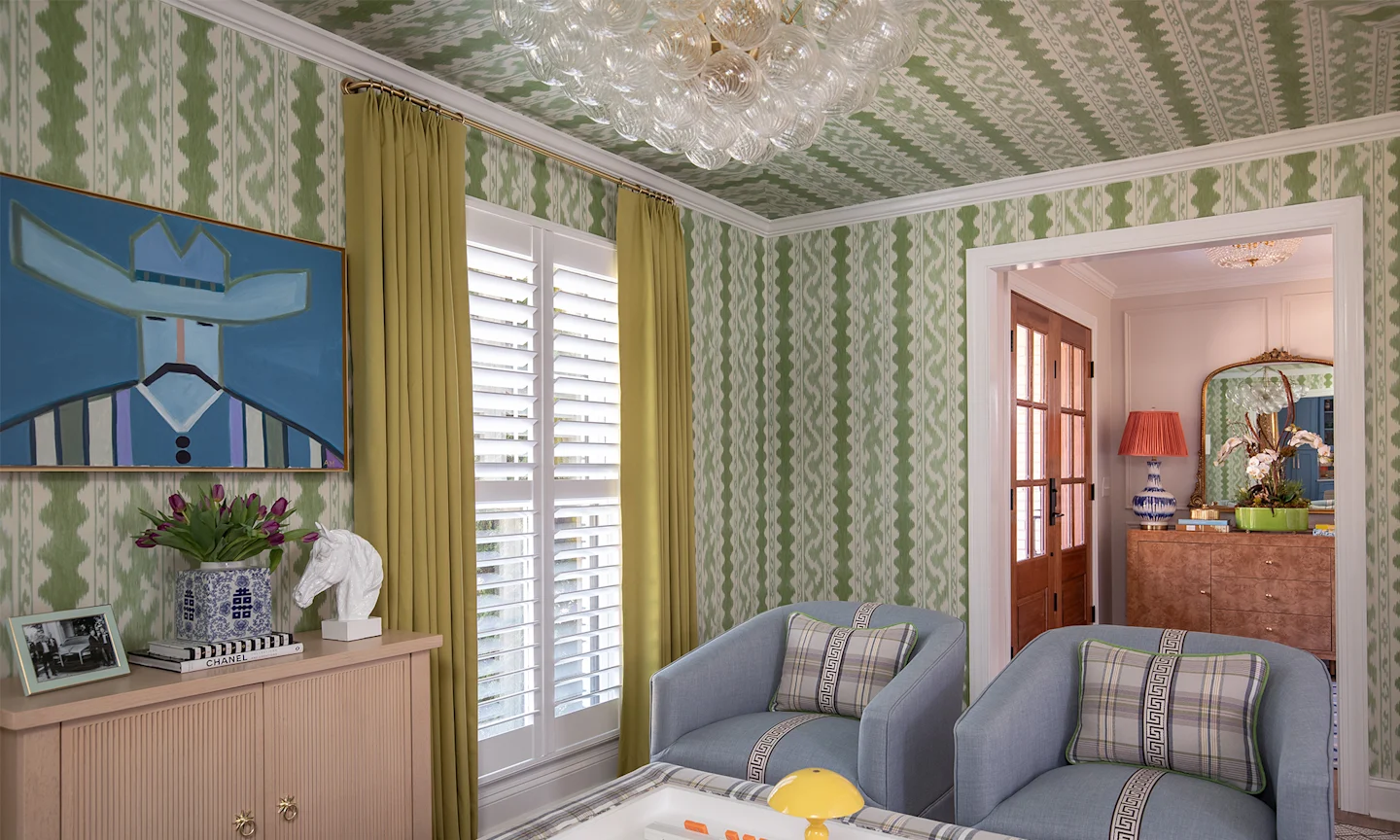 Sitting room with green striped wallpaper on the walls and cieling.