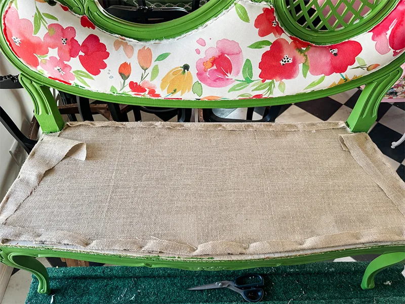Burlap stapled over the just webbing of the settee' seat.