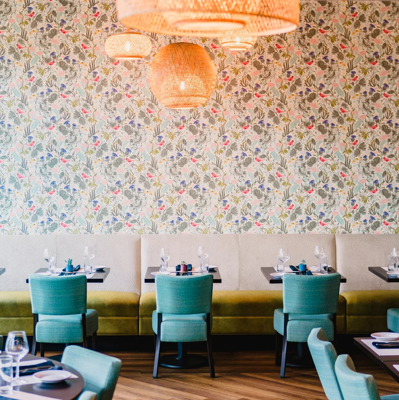 Light floral wallpaper above a restaurant booth.