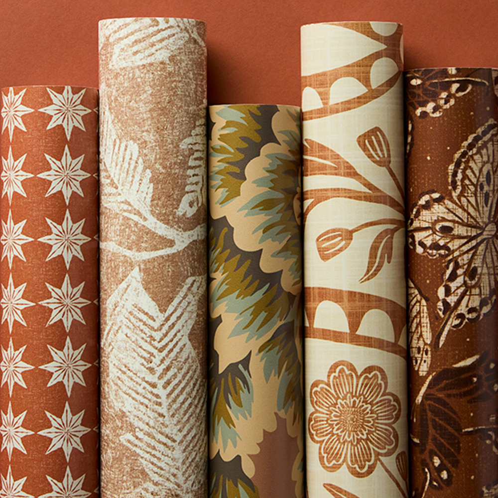 Rolls of terracotta red wallpaper.