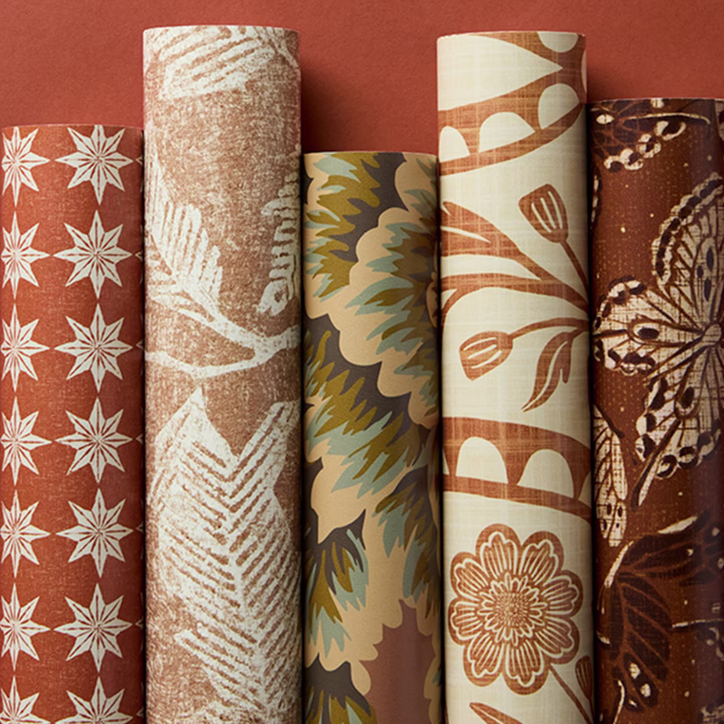 Rolls of terracotta red wallpaper.