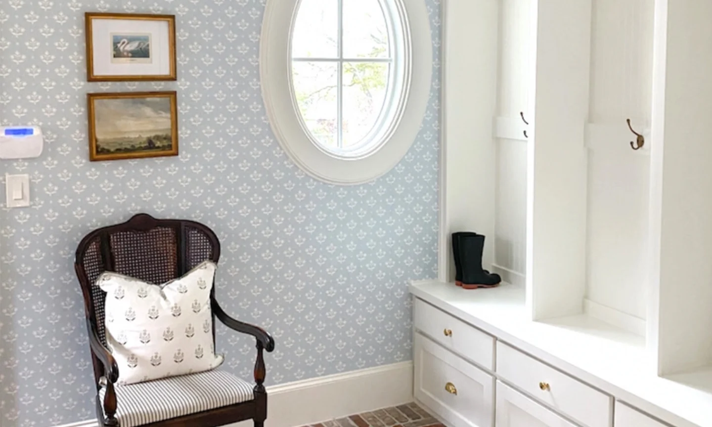 Entryway with blue block print medallion wallpaper.
