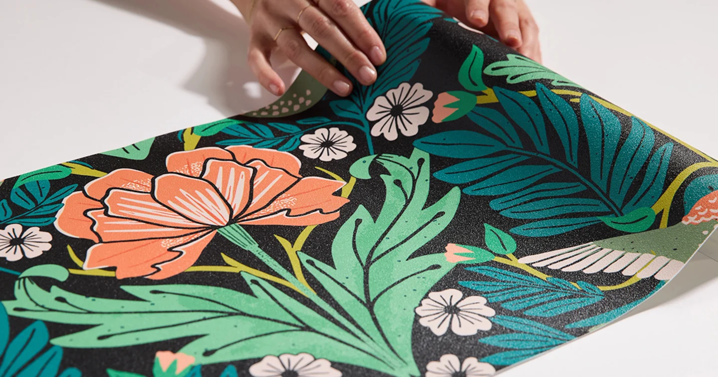 Hand with a swatch of vinyl wallpaper