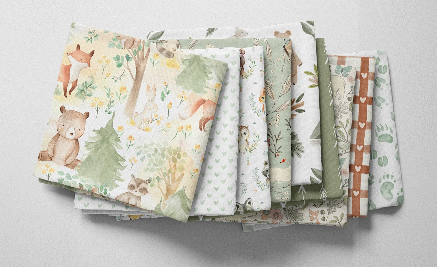 Colorful folded Spoonflower fabric with a woodland baby girl or boy theme