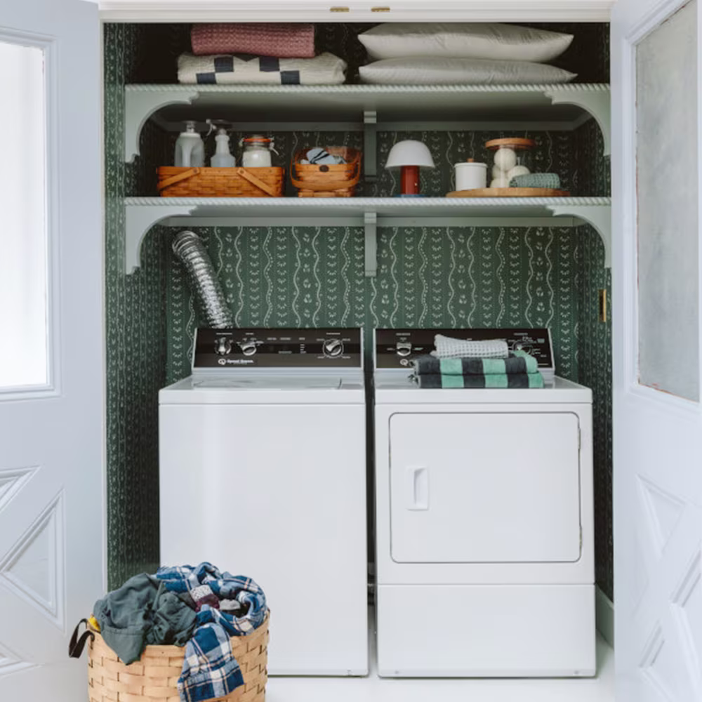 Pine green striped wallpaper in a laundry closet. 