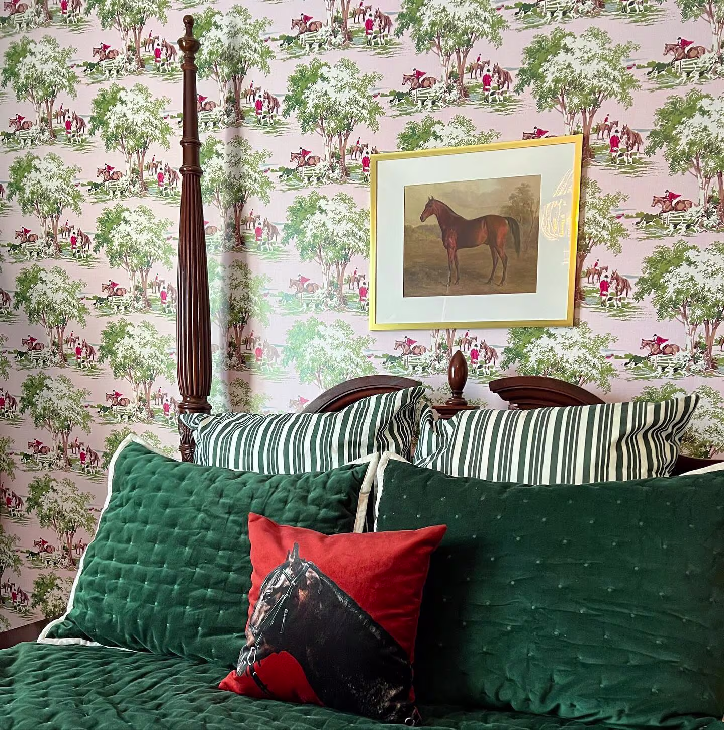 Bedroom with equestrian wallpaper and art.