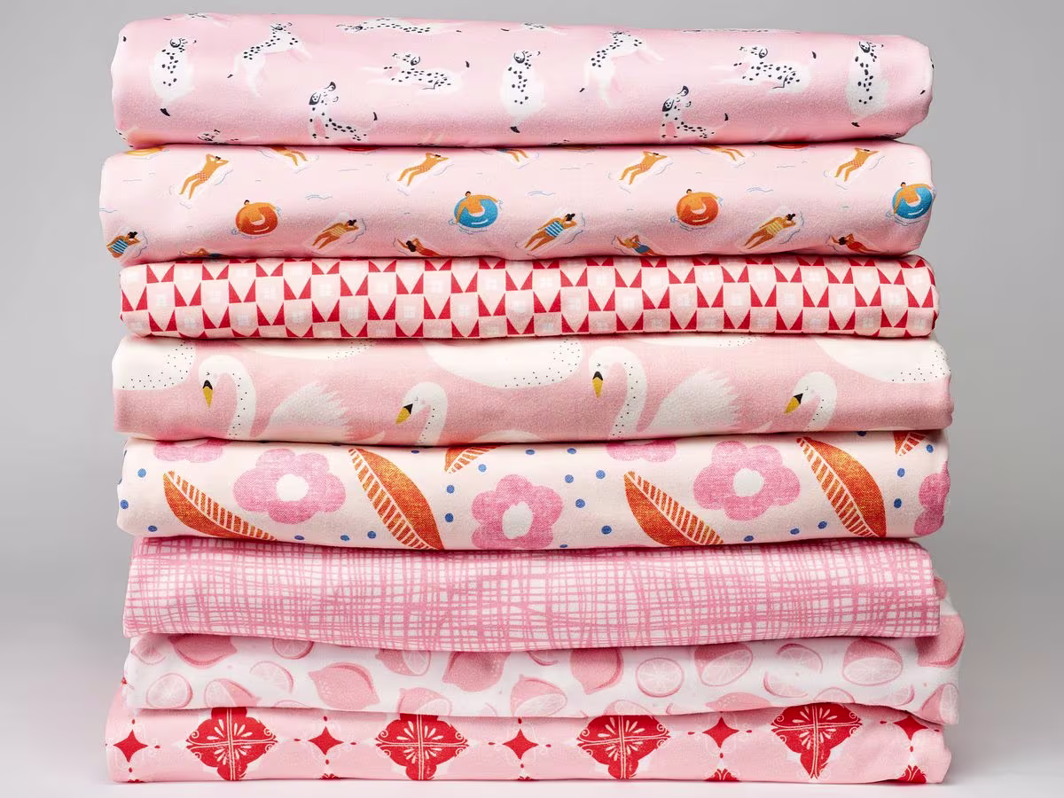 A stack of whimsical pink fabrics on Organic Cotton Knit