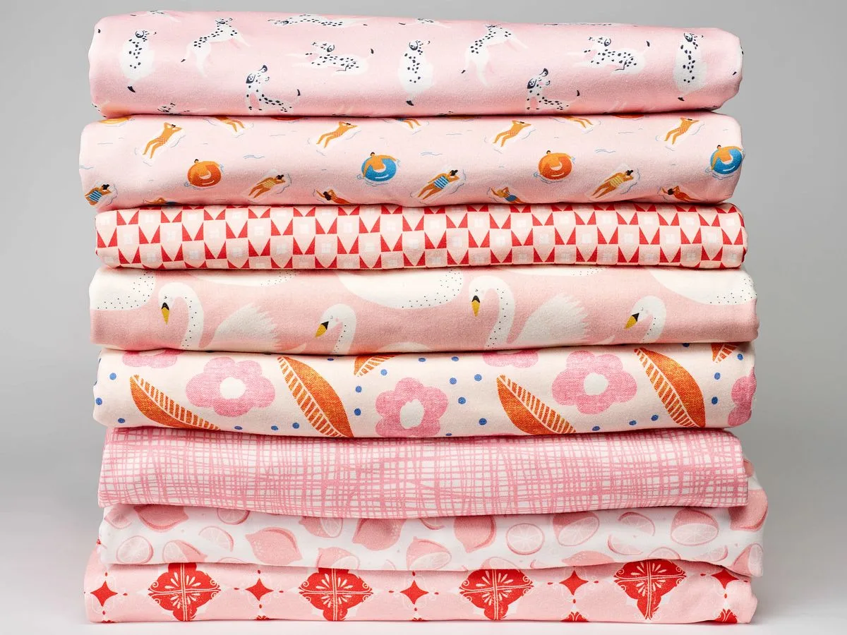 A stack of whimsical pink fabrics on Organic Cotton Knit