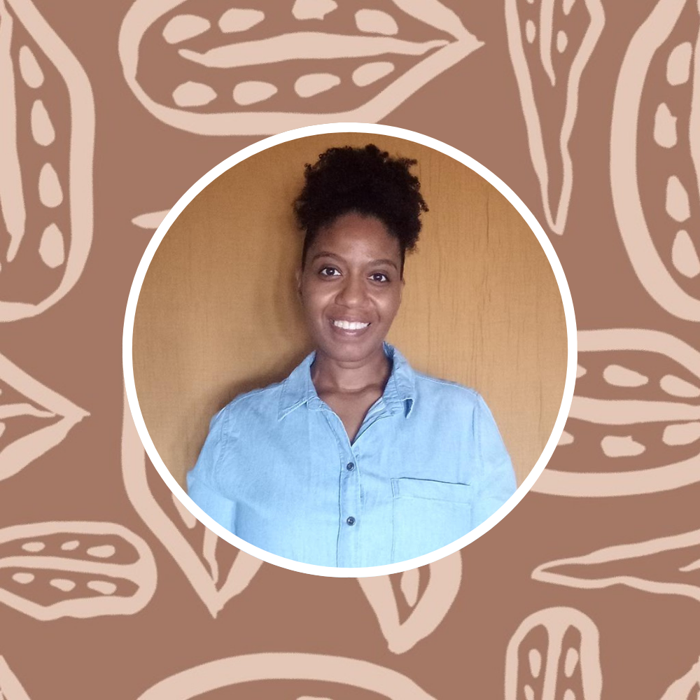 Headshot of Annette Brown with one of her prints in the background.