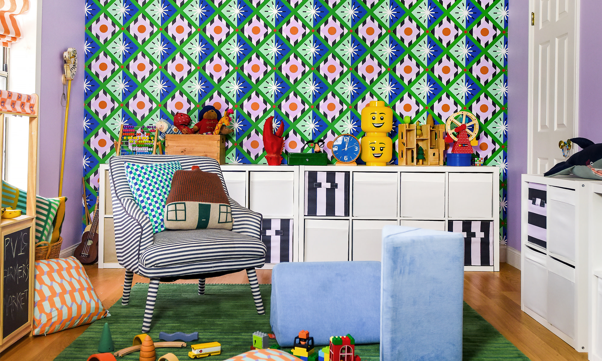 Kids playroom with green, blue and pick geometric wallpaper.