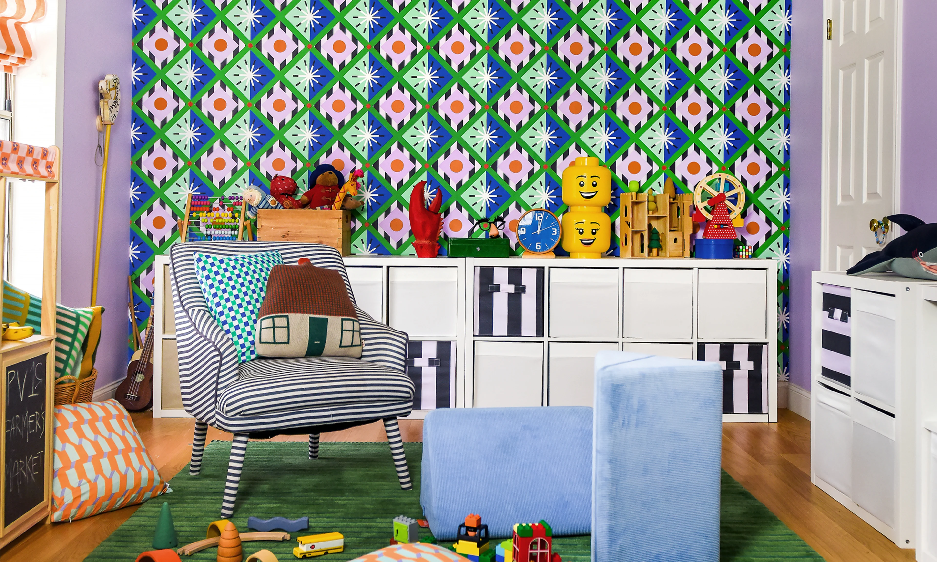 Kids playroom with green, blue and pick geometric wallpaper.