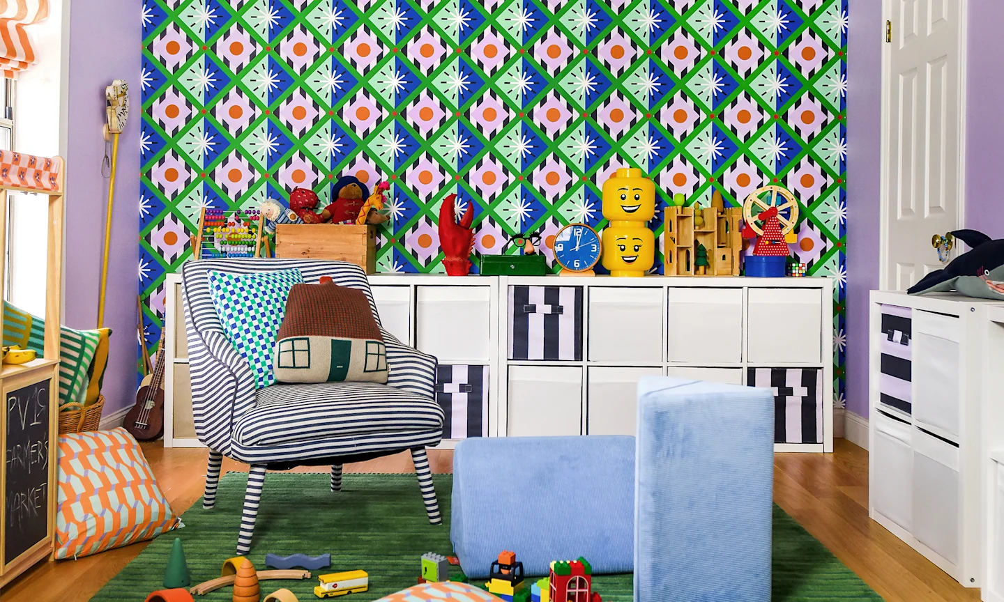 Kids playroom with green, blue and pick geometric wallpaper.