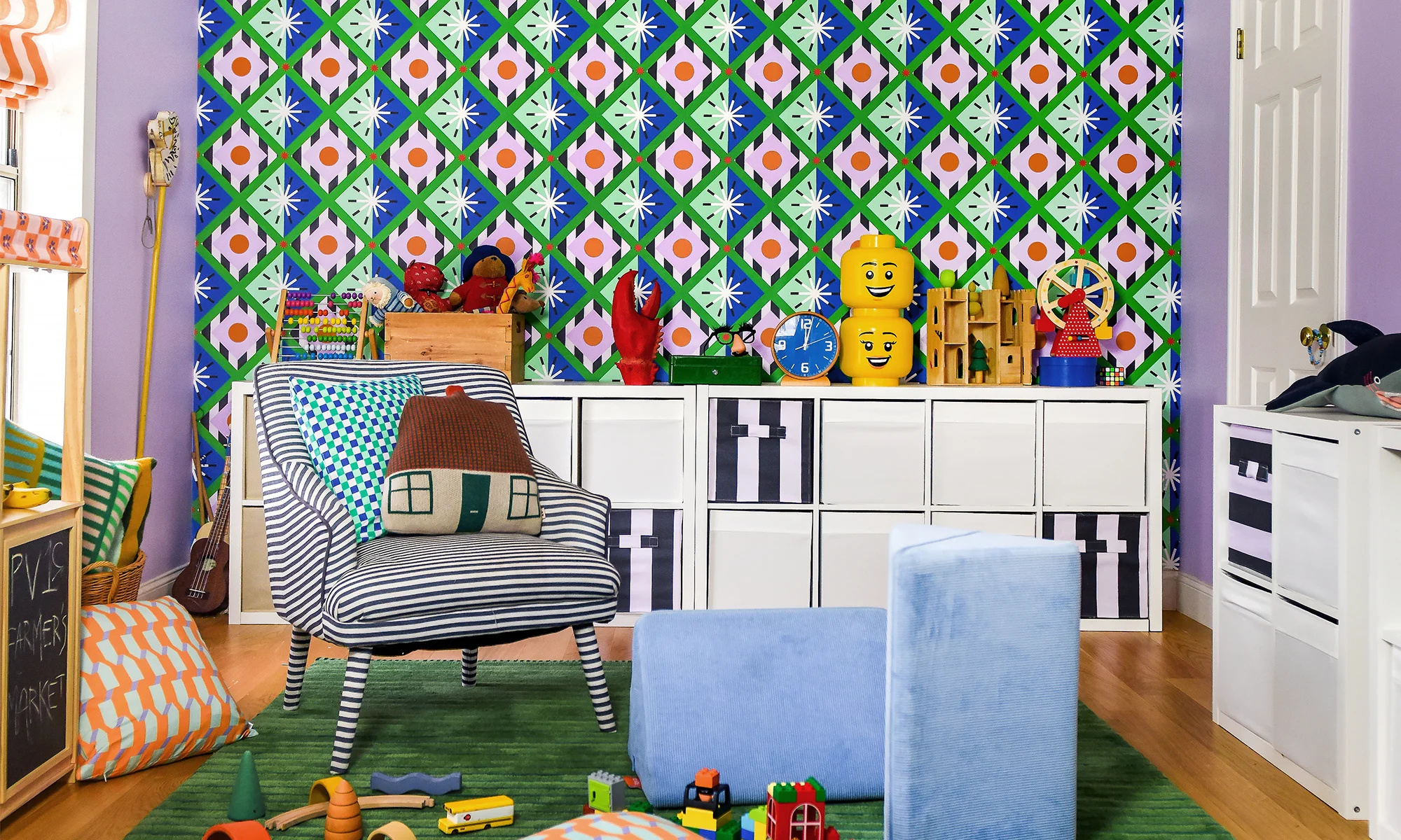Kids playroom with green, blue and pick geometric wallpaper.