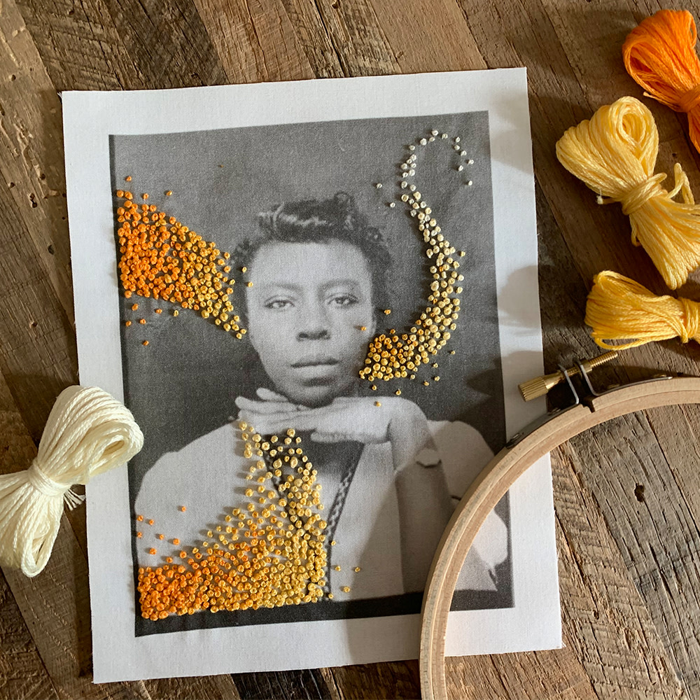 Piece of fabric with a photo of woman and embroidered details.