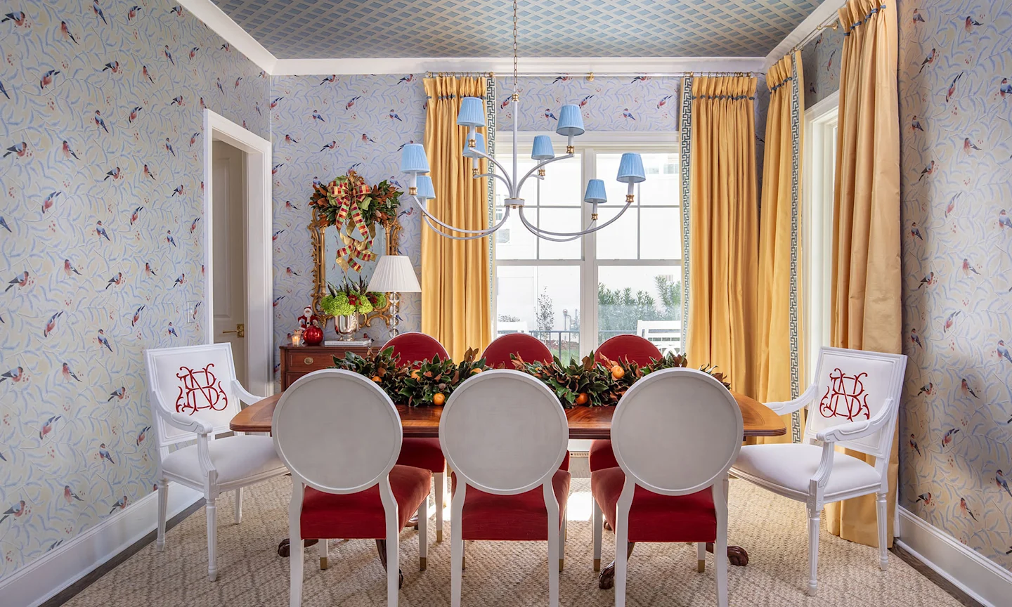 Dining room with bird silver metallic wallpaper and holiday decor.