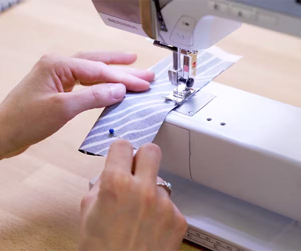 Sewing the long side of one of the hanging tabs.