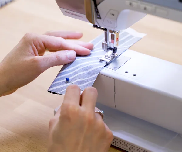 Sewing the long side of one of the hanging tabs.
