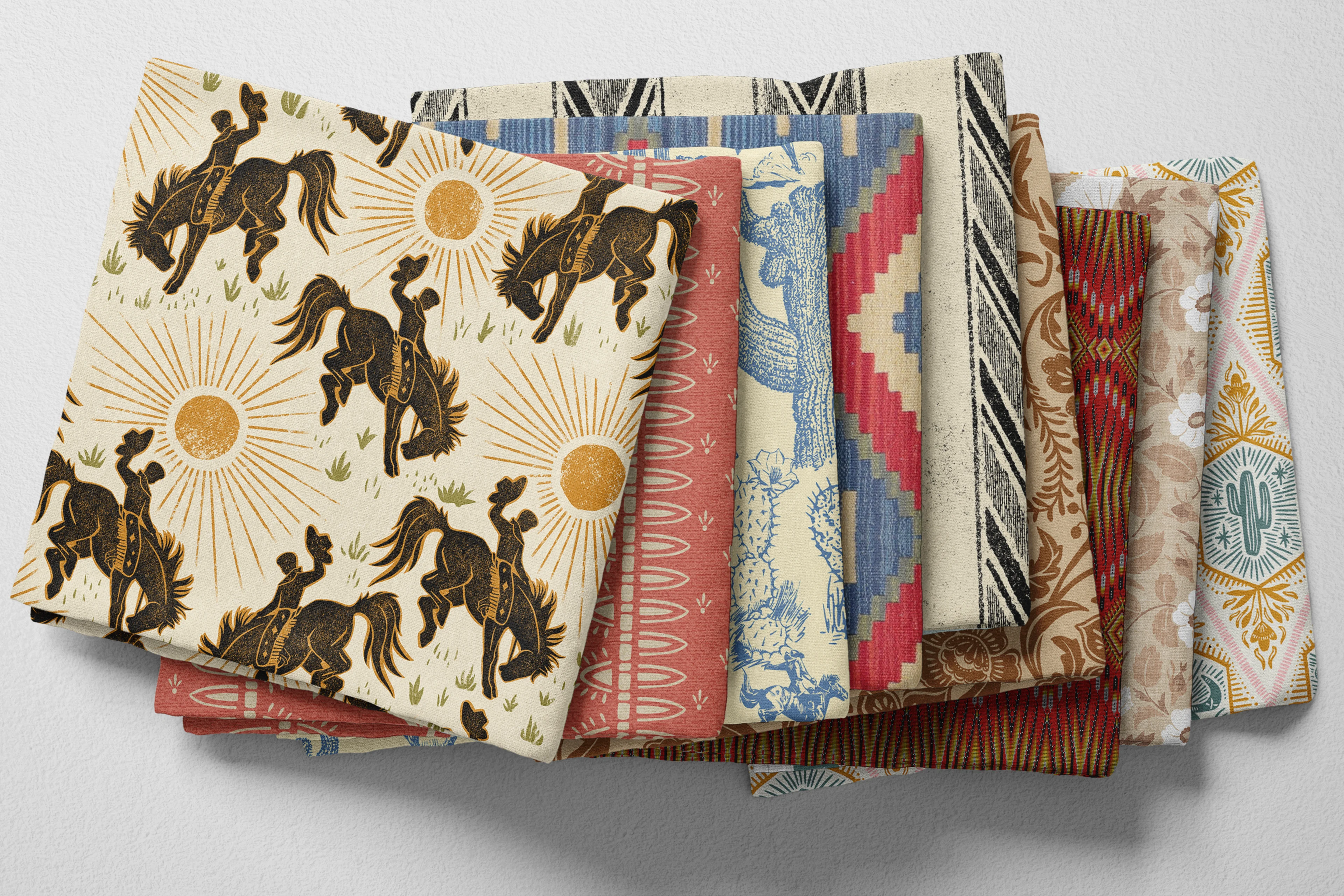 Colorful folded Spoonflower fabric with a western rodeo theme.
