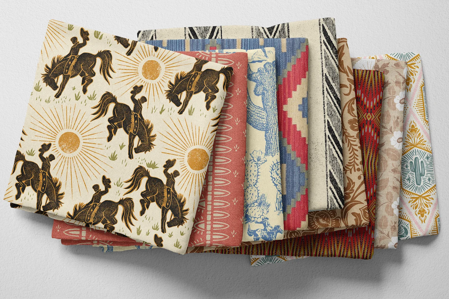 Colorful folded Spoonflower fabric with a western rodeo theme.