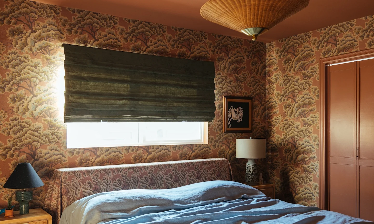 Bedroom with grasscloth wallpaper and matching headboard