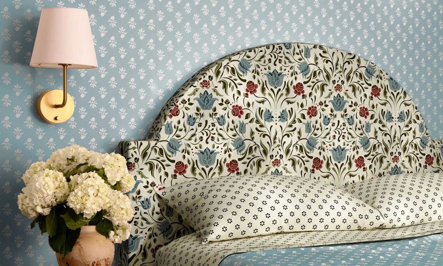 Bedroom with blue wallpaper, headboard and bedding is designs by spoonflower artist Ali Anni.