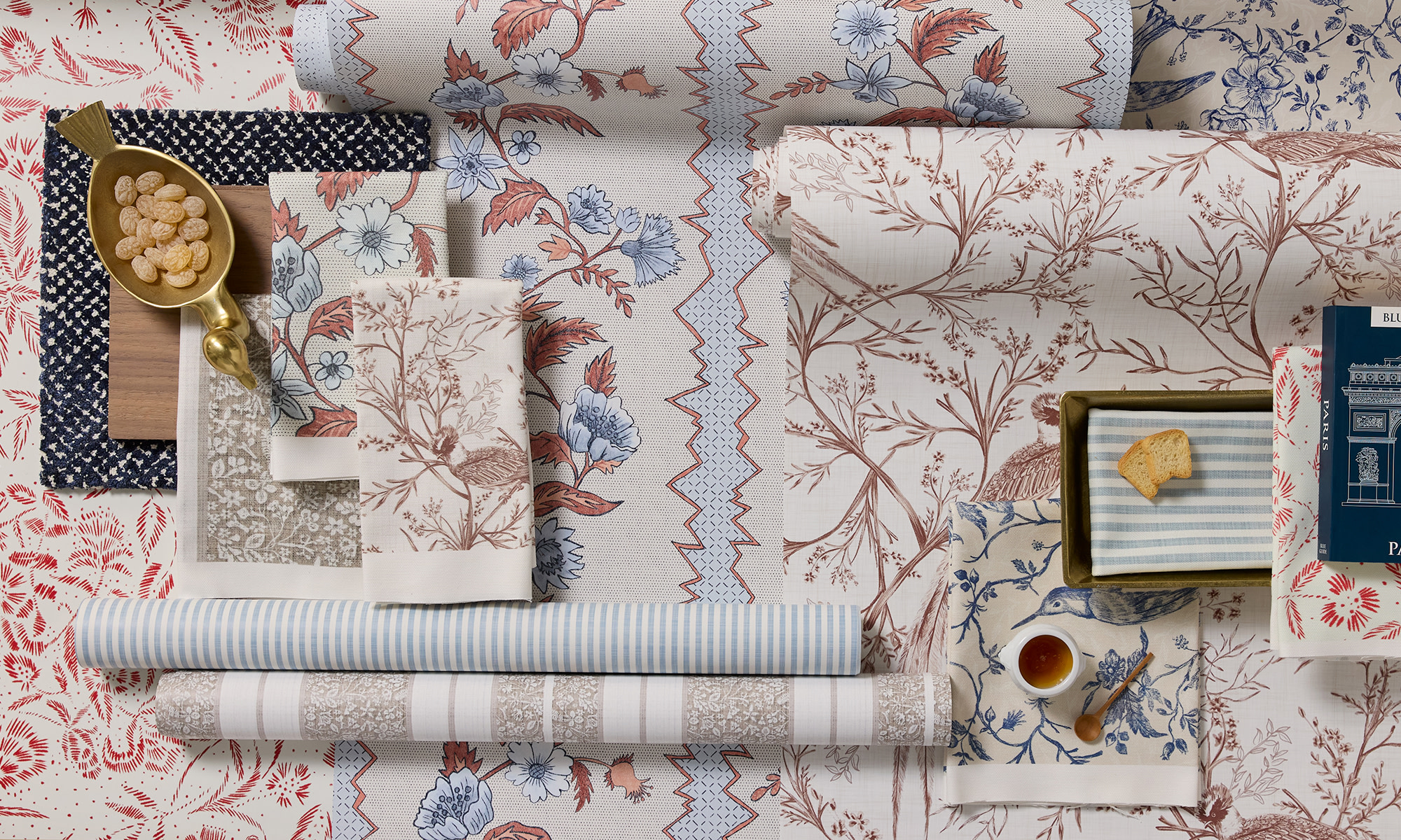 French country wallpaper rolls and fabric swatches.