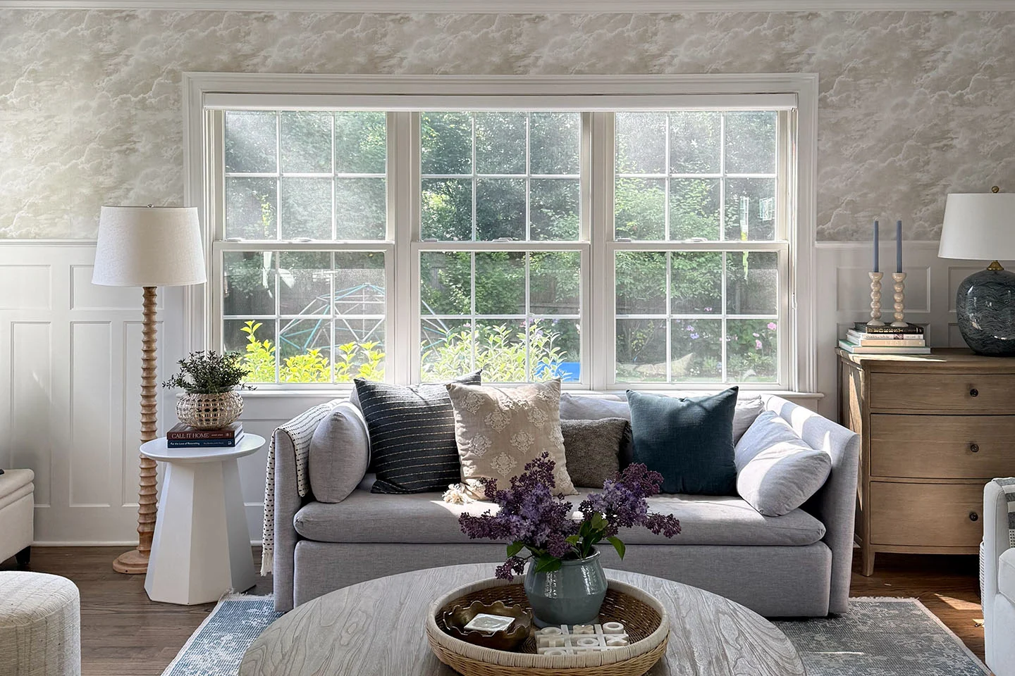 Living room with tasteful cloud wallpaper.