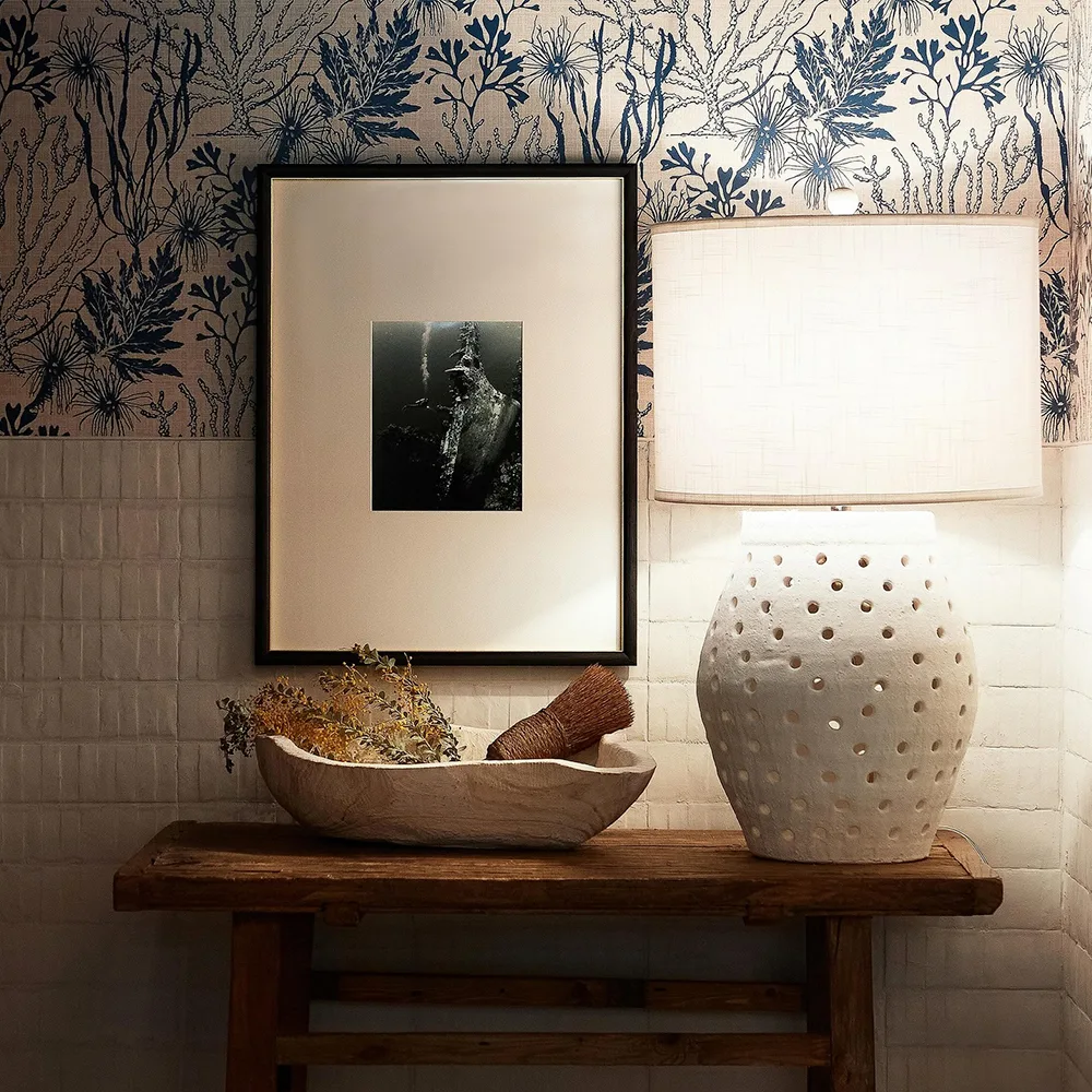 Blue and cream coral wallpaper in a bathroom space.