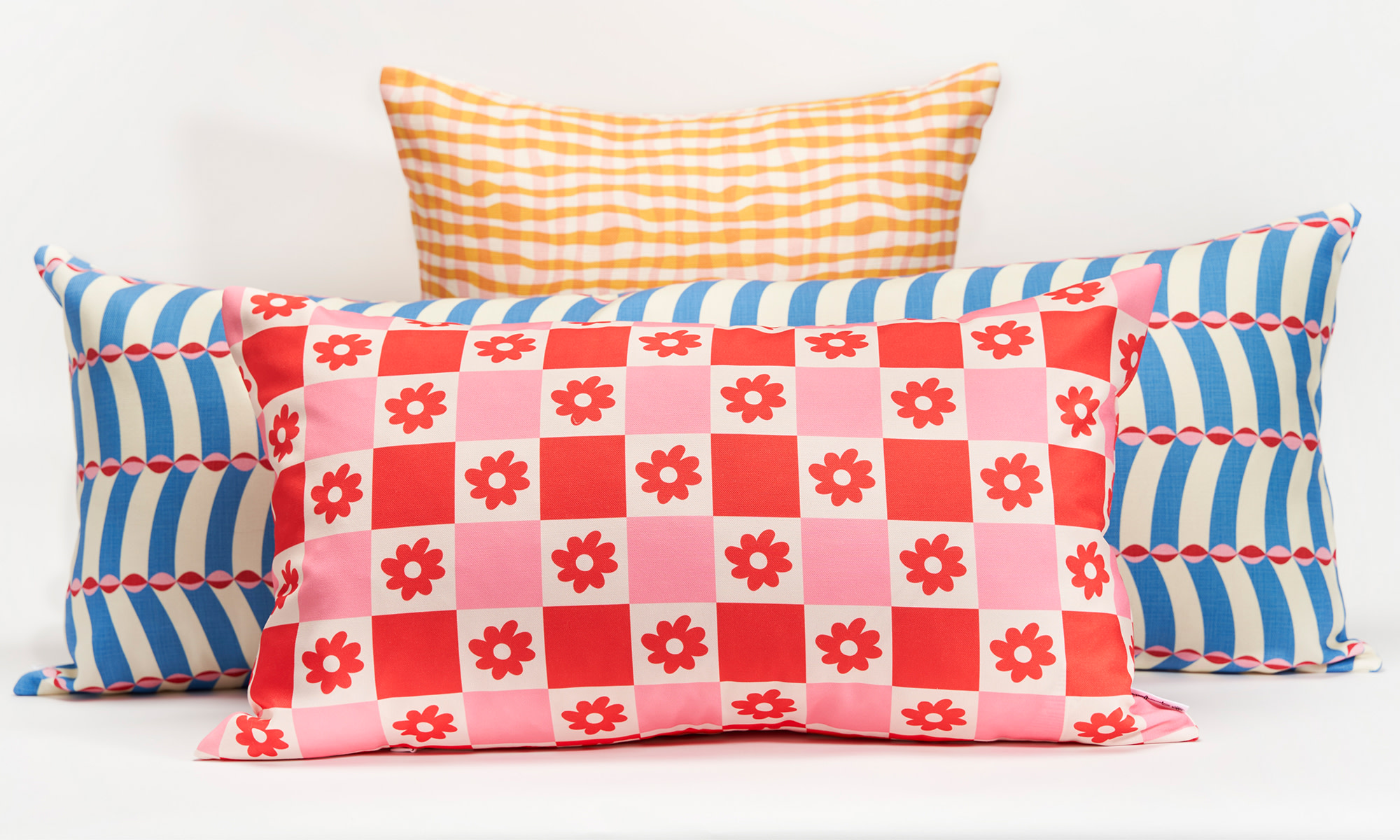 Various throw pillows with different patterns on a white background.