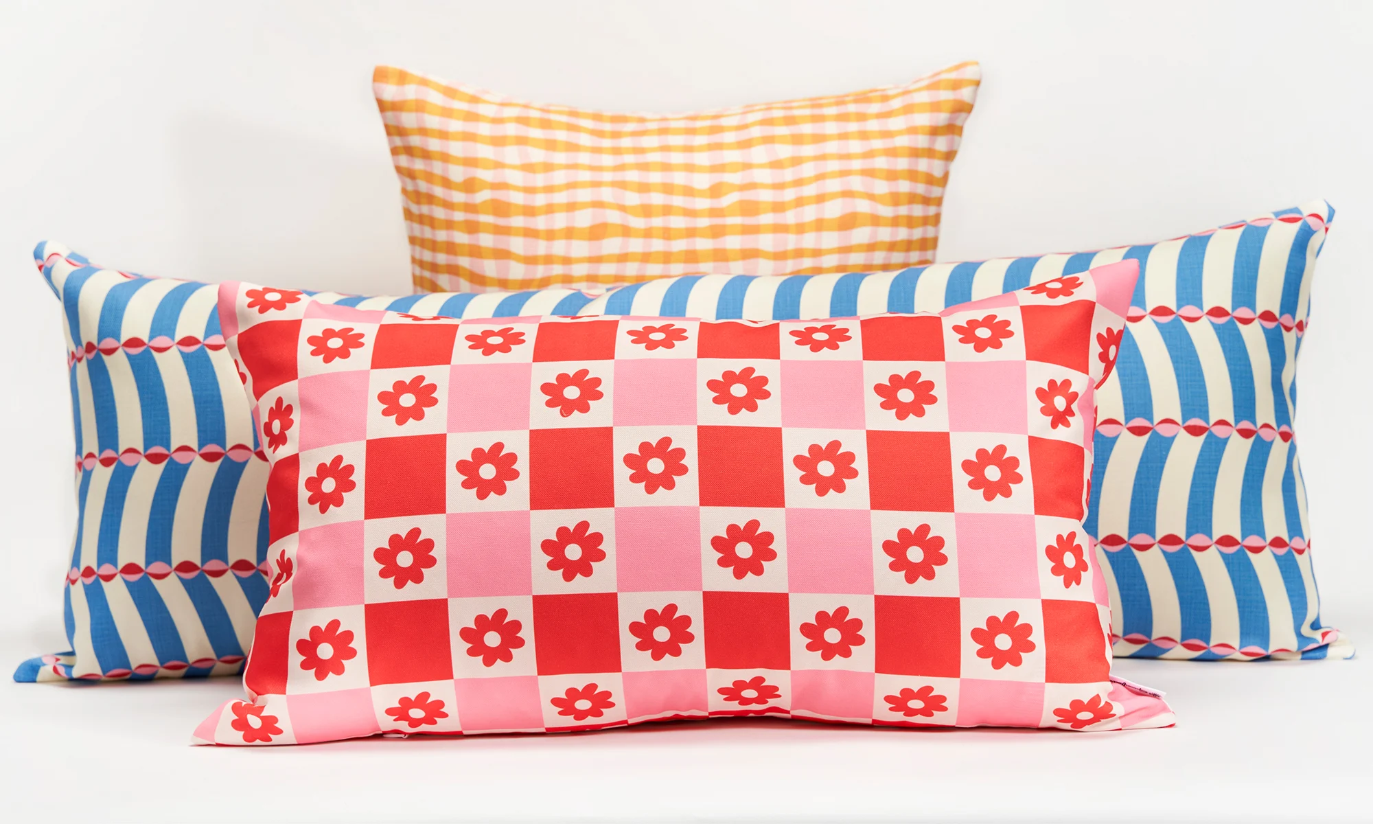 Various throw pillows with different patterns on a white background.