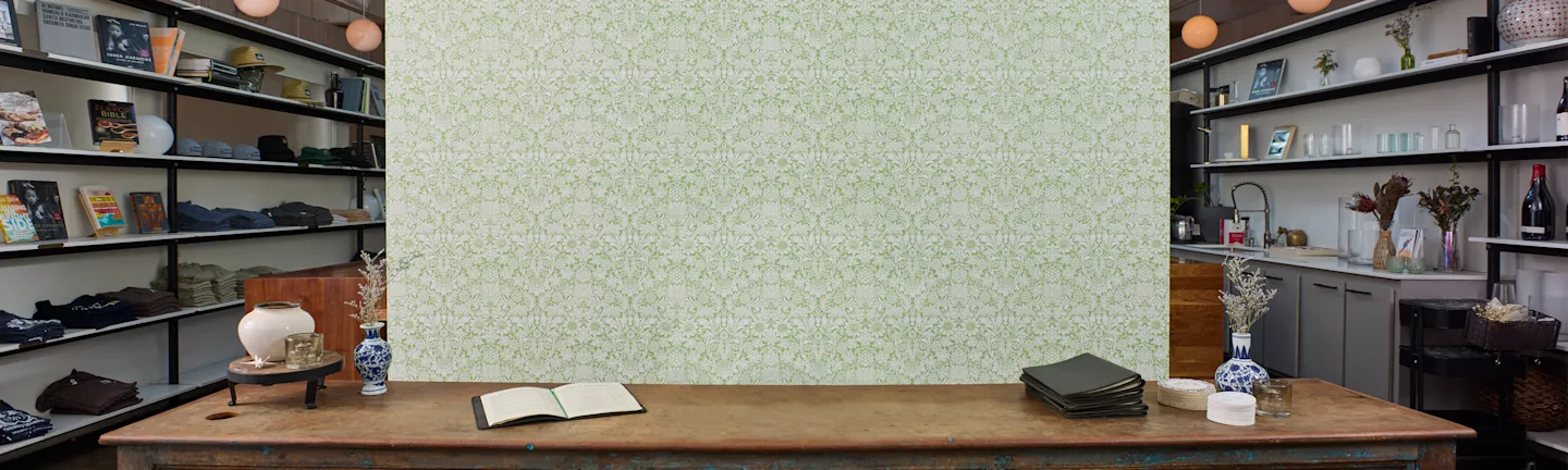 Vinyl wallpaper with a green ornate floral design in a commercial space.