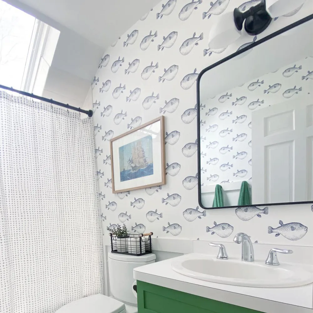 Bathroom with fish wallpaper.