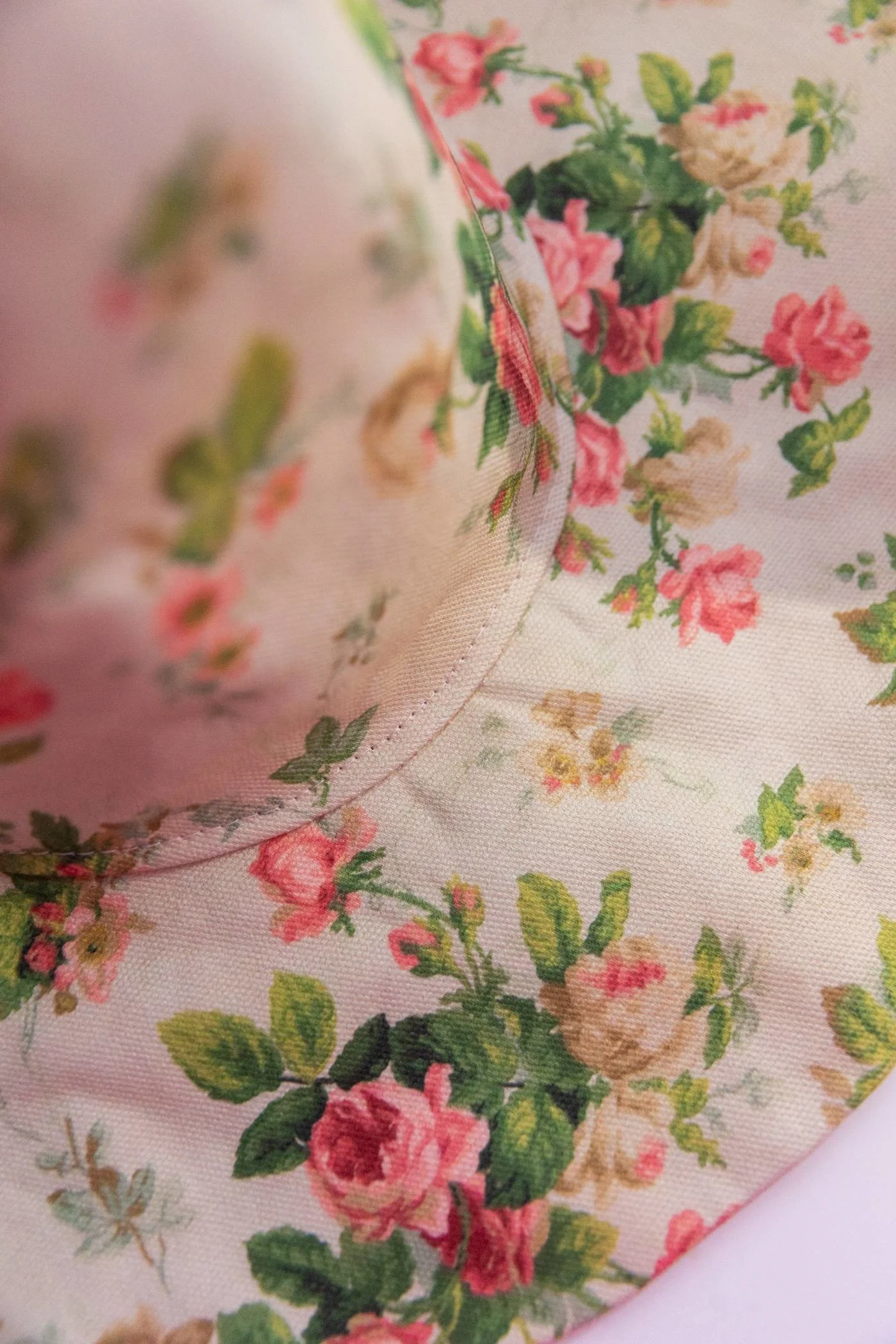 From an angle, we see the completed witch hat. The stitches that connect the cone to the brim are in focus.